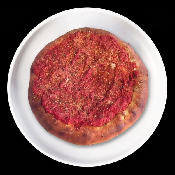 Round flatbread with red tomato sauce and spices on a white plate.
