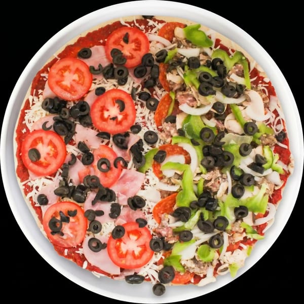 Uncooked pizza with half ham, tomatoes, olives, and half pepperoni, green peppers, onions, mushrooms.